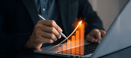 A businessman reviewing a rising sales chart on a laptop